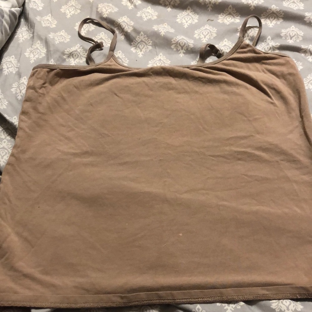 Medium sized tan spaghetti strap shirt barley worn